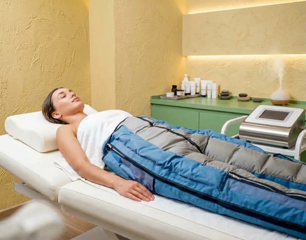 Botas de presoterapia sobre las piernas, con cámaras de aire para el drenaje.